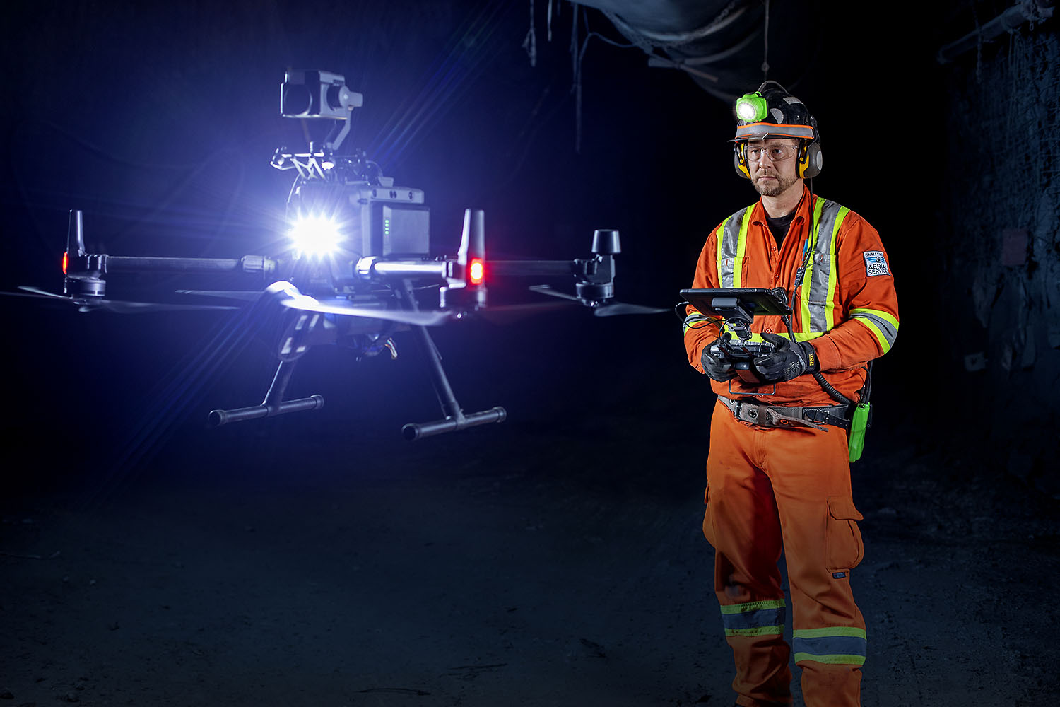 UAS Inc. pilot flying a drone underground with a light-flare from the drone illuminating the tunnel